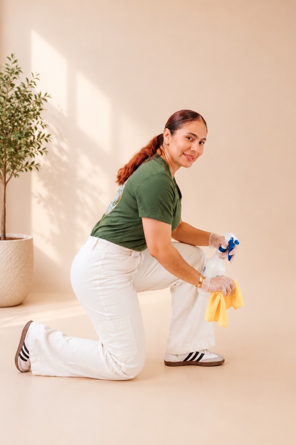 Explosion Cleaning Service team member cleaning with a spray bottle
